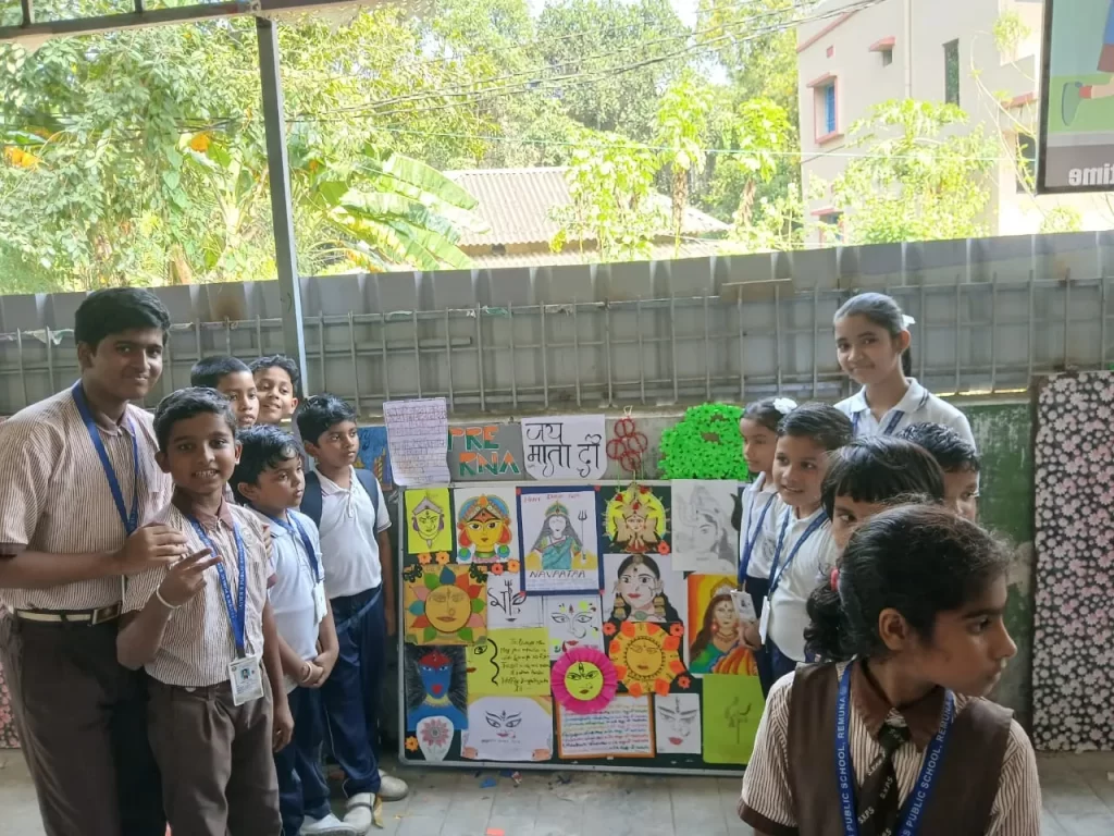 Students standing in front of decorative board